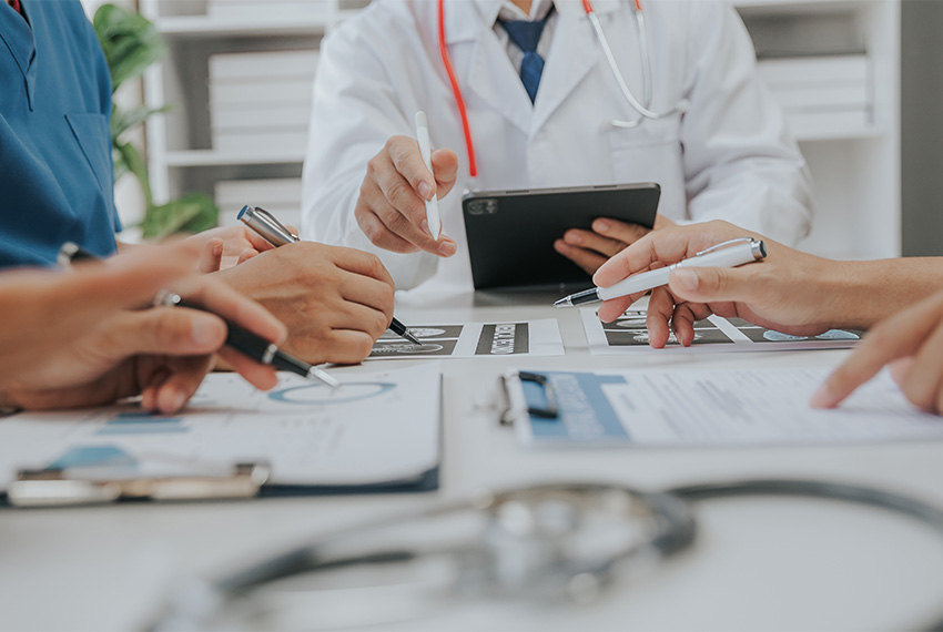 Medical Staff reviewing paperwork with consultant